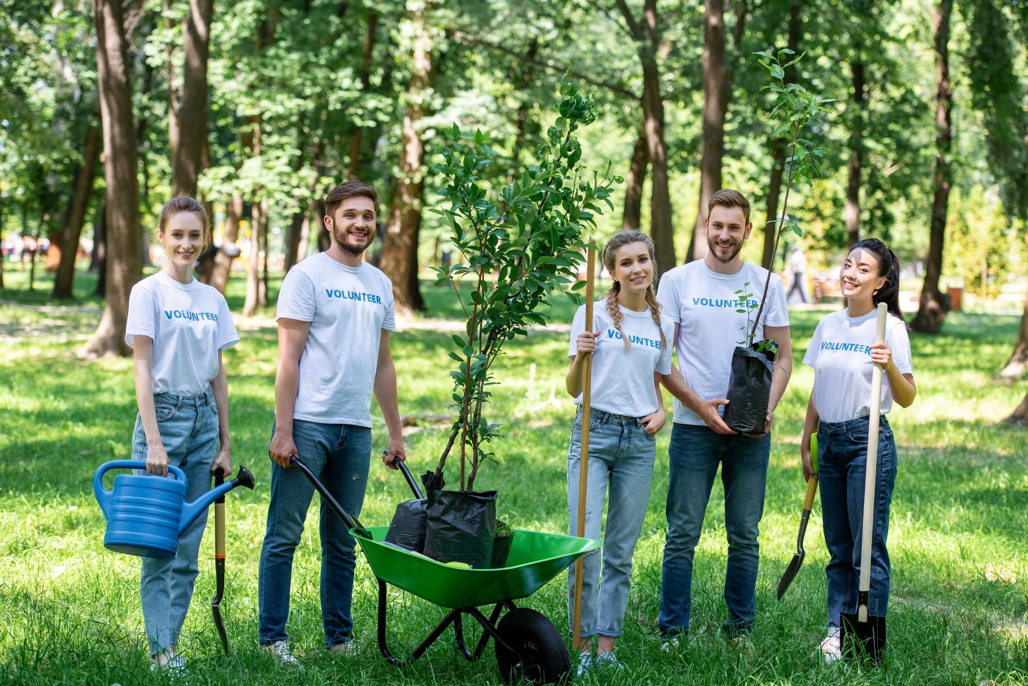 friends-volunteering-and-planting-trees-in-park-together